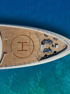 Superyacht from above on turquoise sea