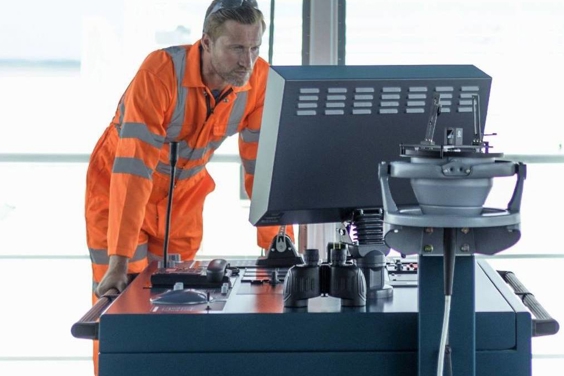 seafarer monitoring controls on a ship's bridge 