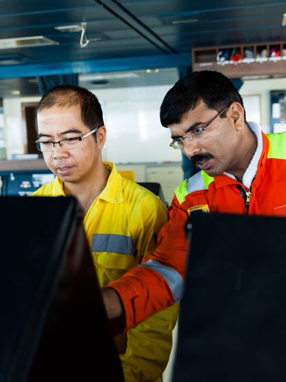 Surveyor instructing crew member on maintenance procedures