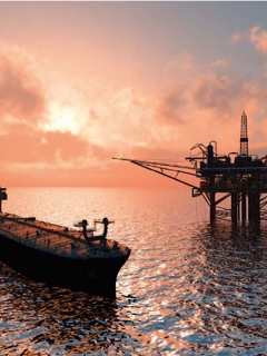 Offshore rig and ship in the sunset. 