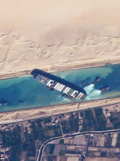 A container ship blocks the Suez Canal. 