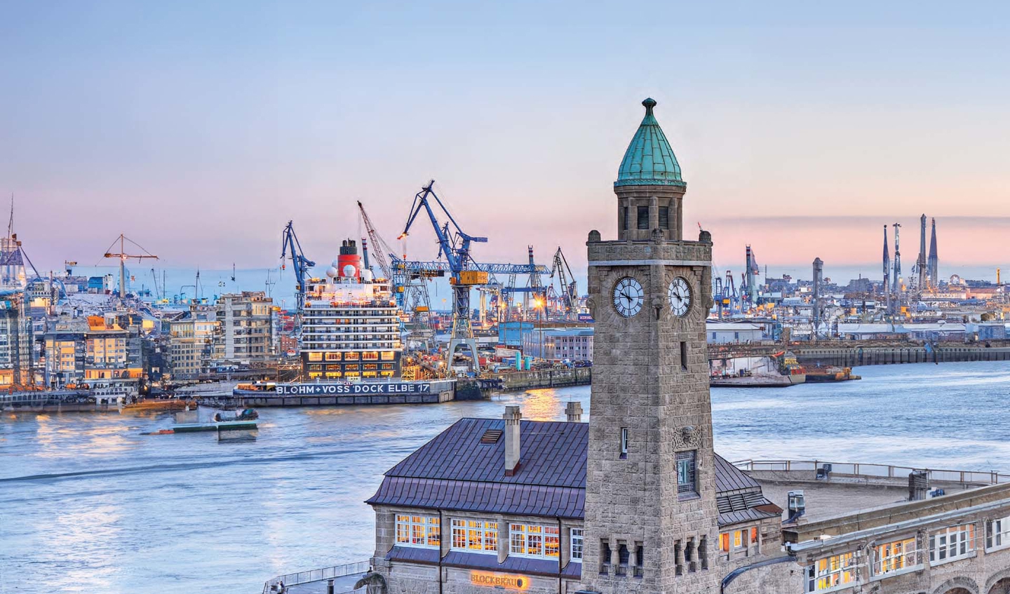 German harbour waters with construction and an old clock tower. 