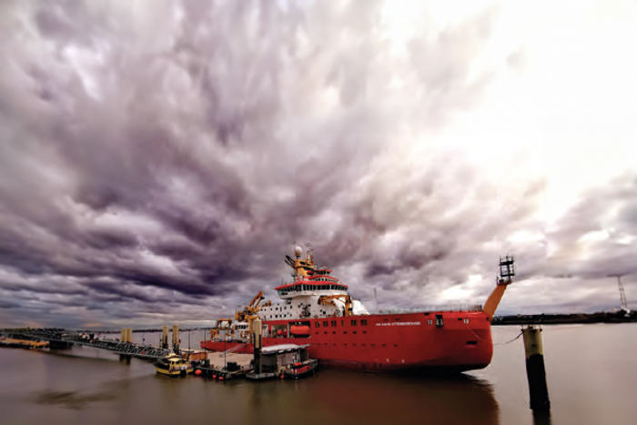 RRS Sir David Attenborough docked on the water.