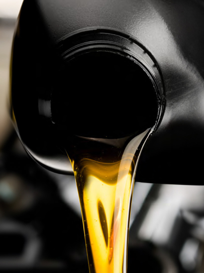 Oil pours out of black jug. 