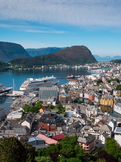 Mountains and harbour with ships at dock.