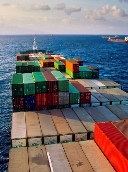 Cargo ship on bright blue sea.