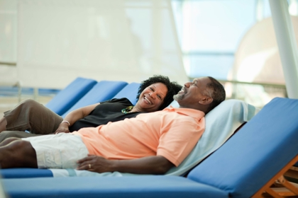 Two cruise passengers recline happily.