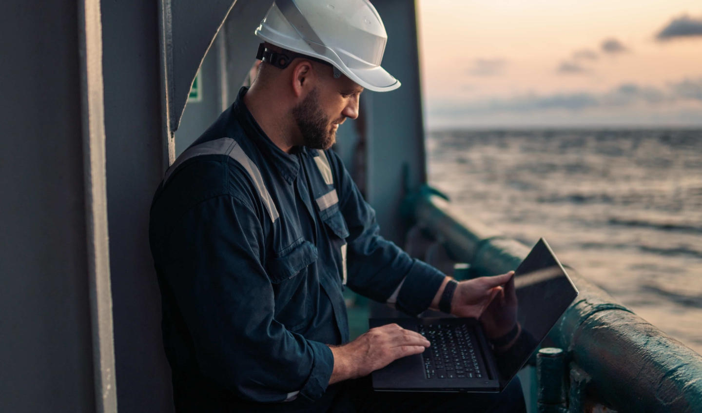 Worker on ship with a clipboard.