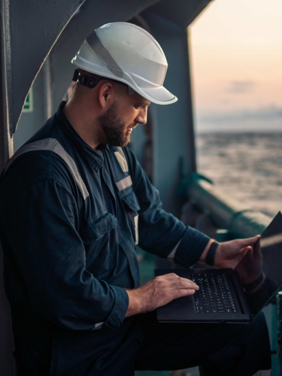 Worker on ship with a clipboard.