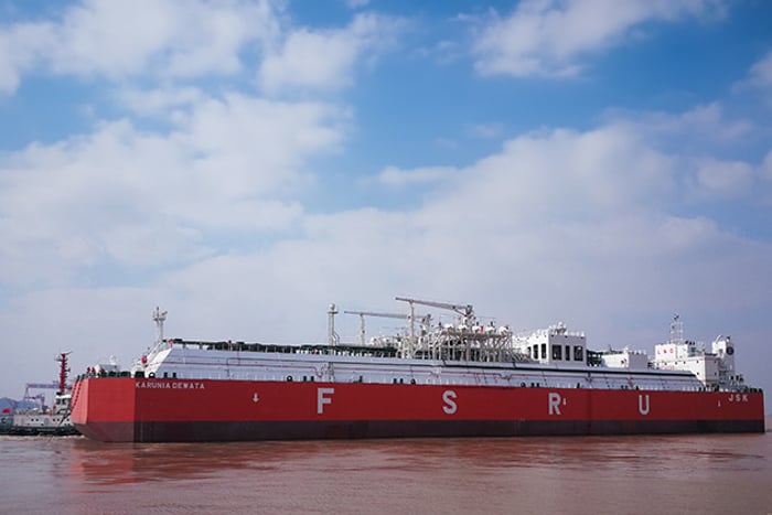 Karunia Dewata FSRU, floats on the water, blue skies.