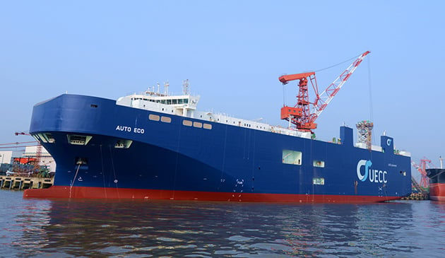 Side angle view of UECC Auto Eco vessel anchored.