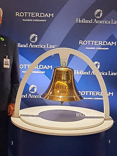 Piet Mast, LR Key Account Development Director, standing next to the bell at the naming ceremony, in front of event signage.