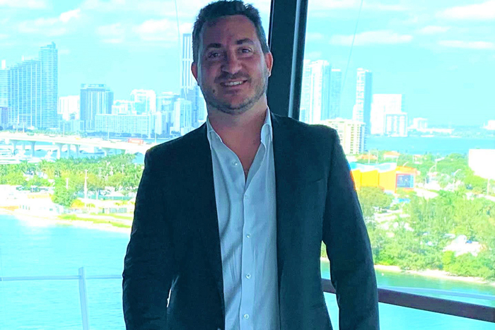 Photo of Michele Landro, Vice President, Head of Passenger Ships Segment, LR in front of office window with view.