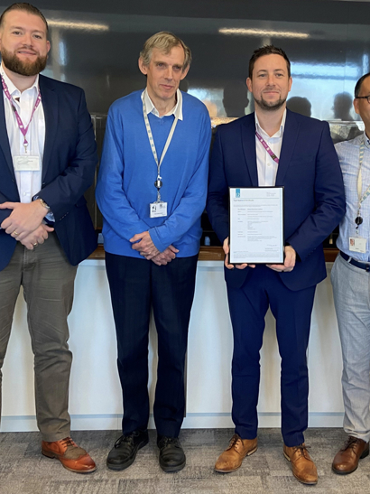 Group photo of Lloyd's Register and Datum Electronics representatives with award for Type Approval.