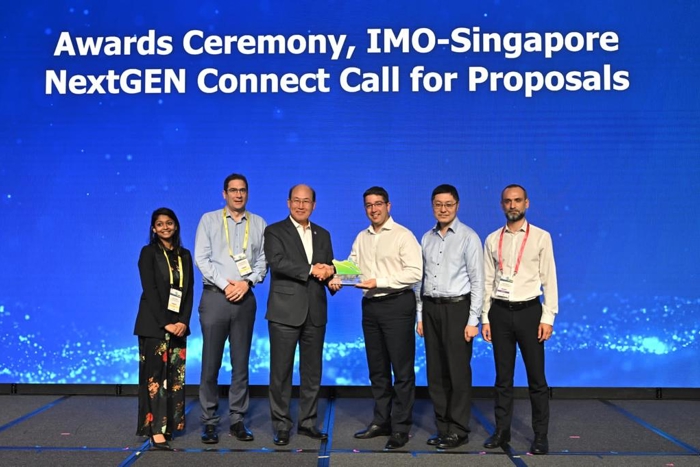 Group photo with members from LR, IMO and Maritime and Port Authority of Singapore (MPA) members, on stage with NextGEN award being presented to recipient.