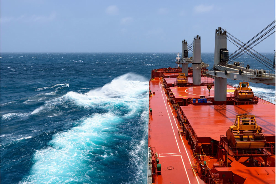 Ship charges through the ocean.