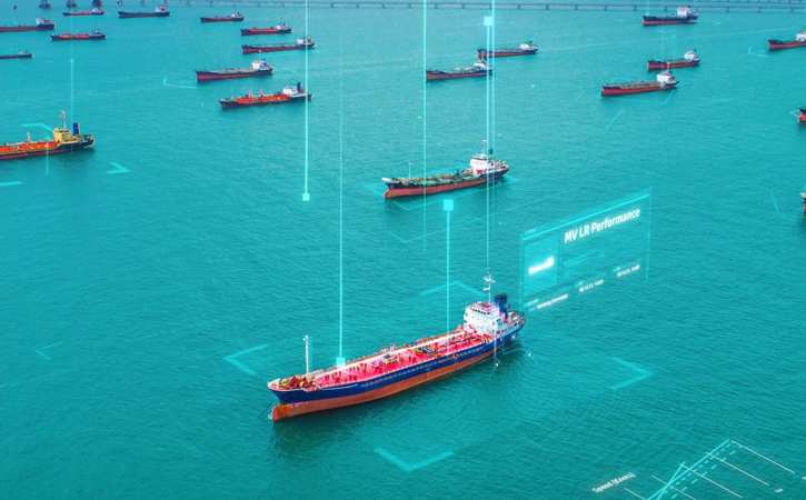 Birds eye view of ships anchored in calm seas. A digital overlay implies the central ship is selected in a user interface, and has the Ship name of MV LR Performance.
