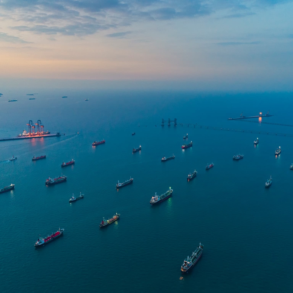 Ships moored at sea at sunset - aerial view