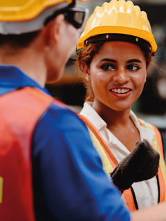 South-Asian Engineer speaking with other Engineers. 