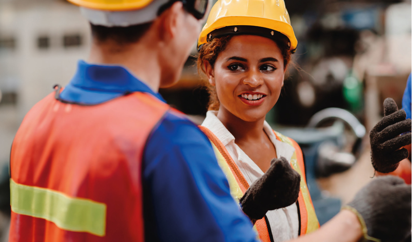 South-Asian Engineer speaking with other Engineers. 