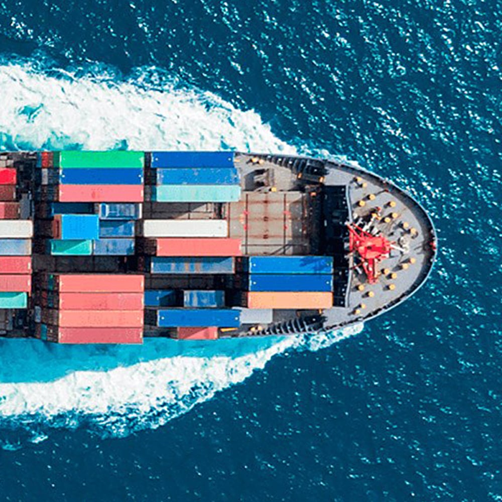 Top view of container ship travelling through the ocean.