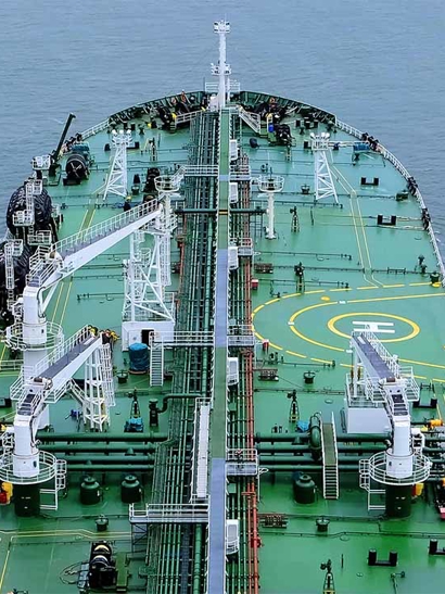 Birds eye view of a green tanker at sea.