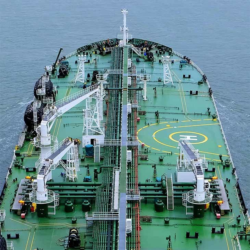 Birds eye view of a green tanker at sea.