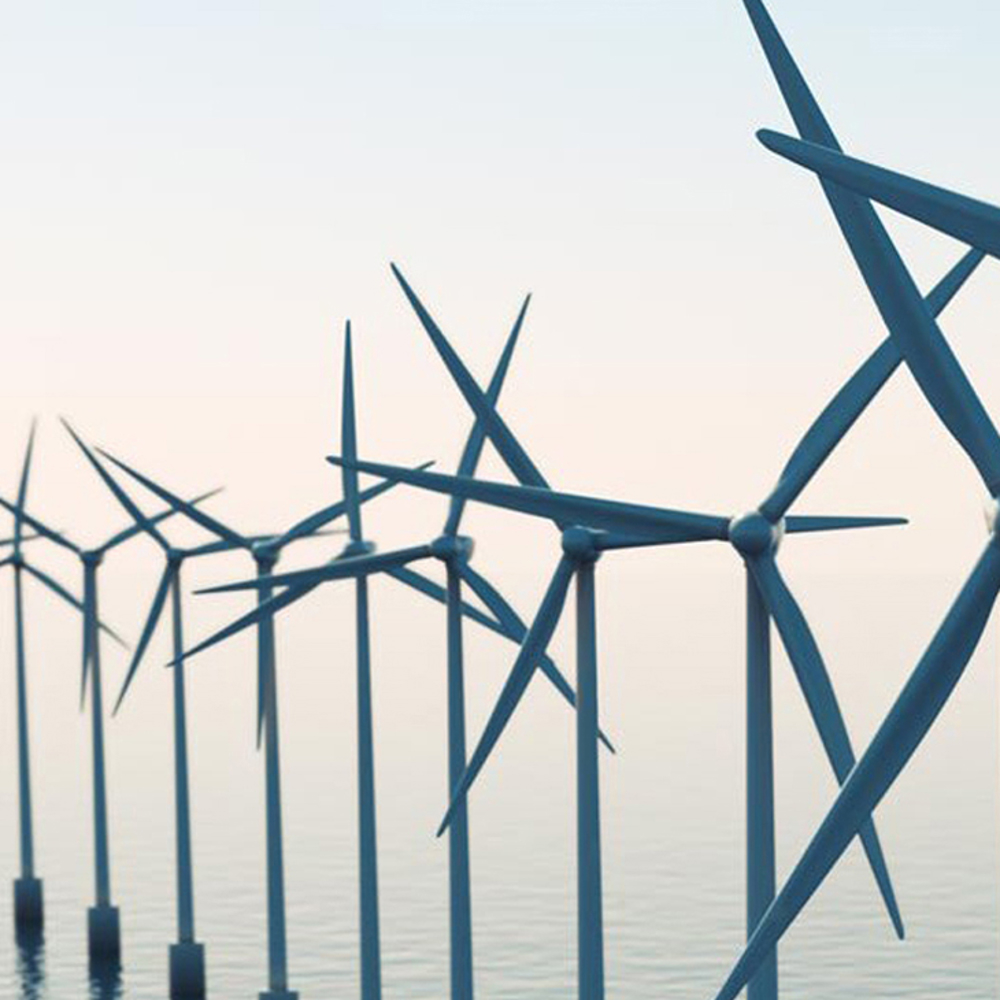 Multiple wind turbine propellers in an offshore wind farm.