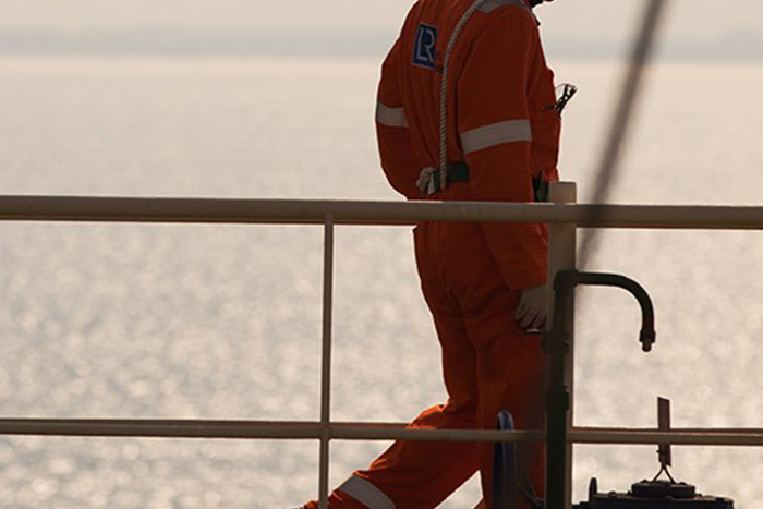Worker walks on an offshore rig.