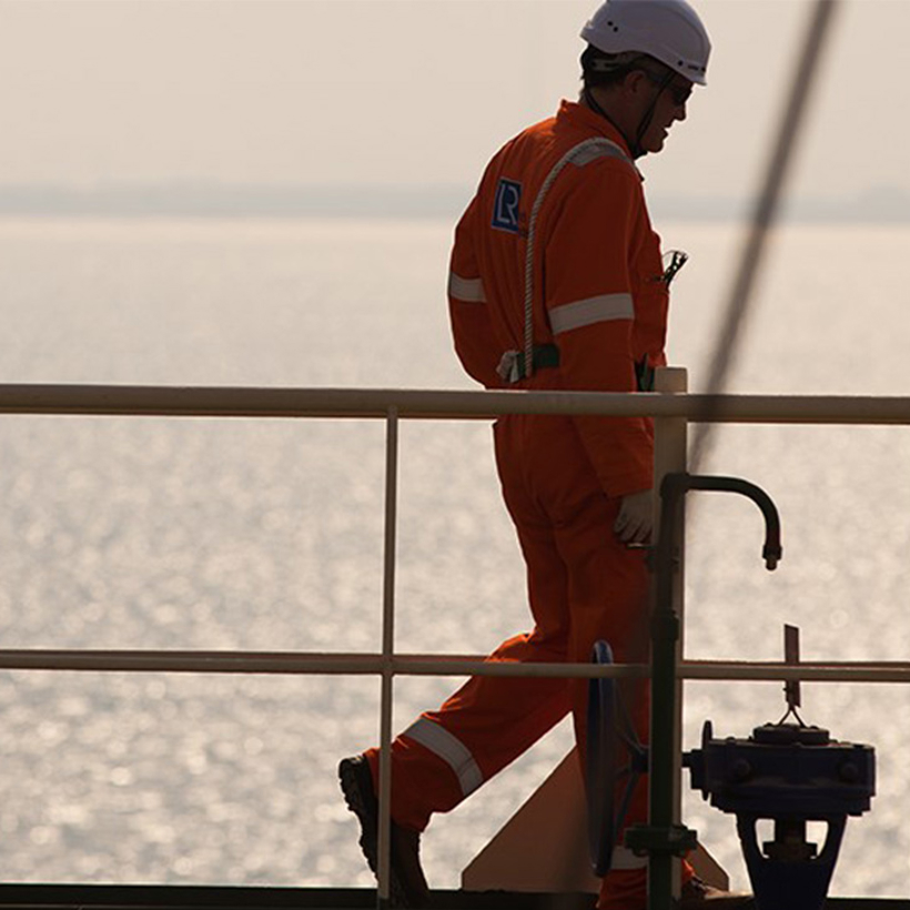 Worker walks on an offshore rig.