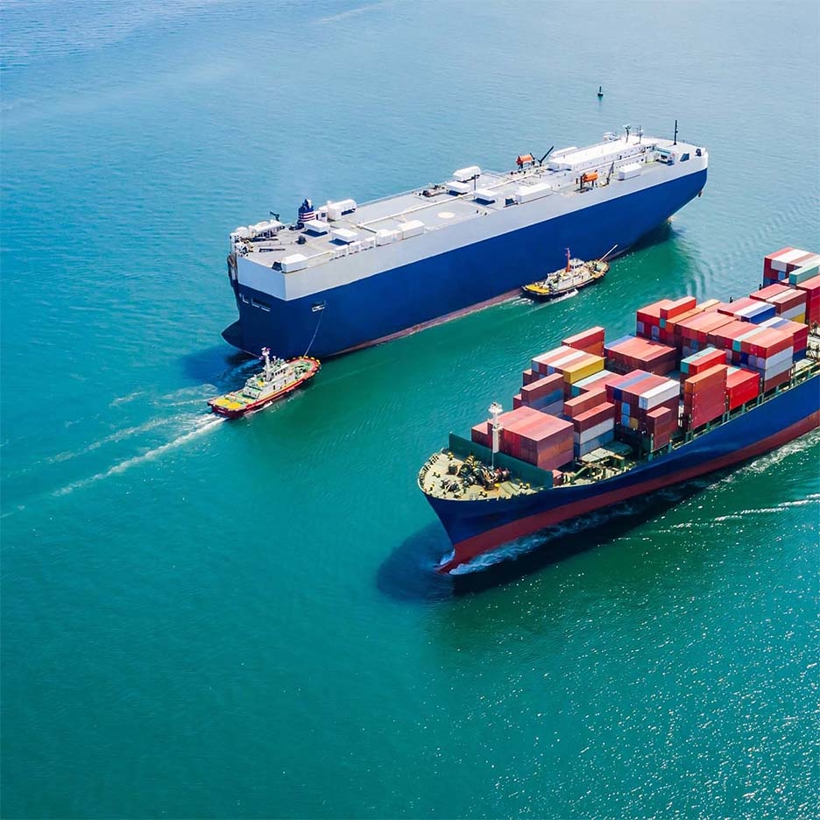 Ships sit on a clear blue ocean.