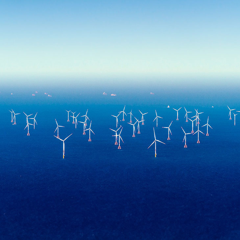 Offshore windfarm on blue seas. 