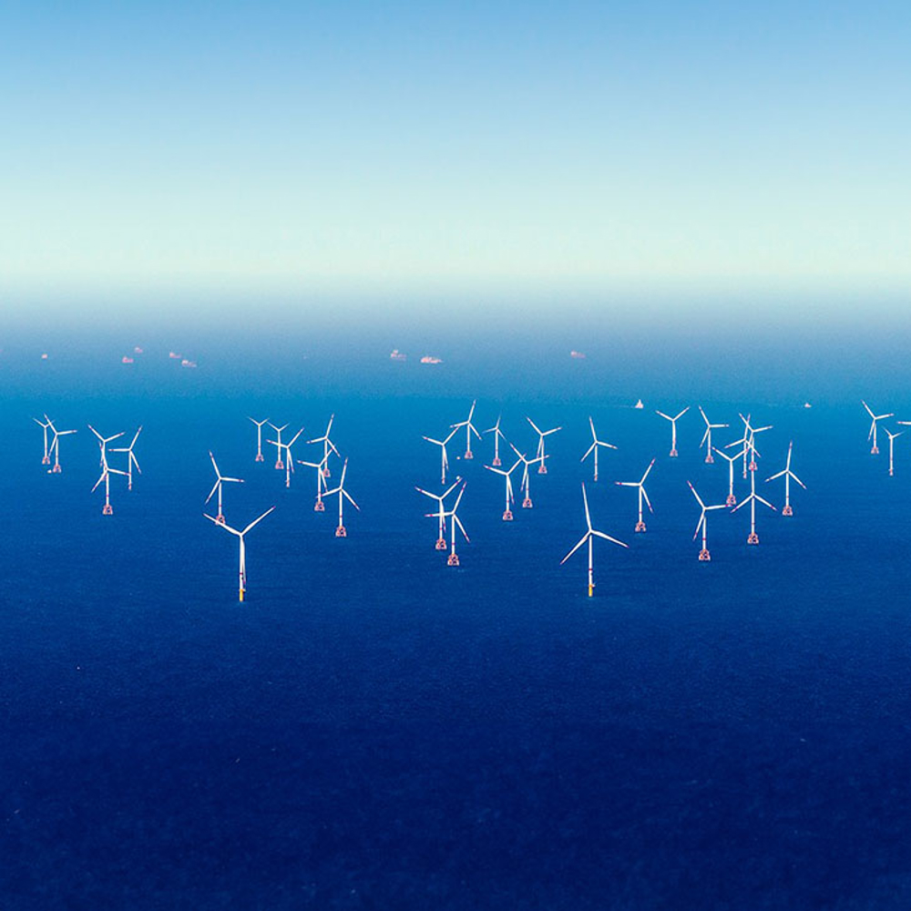 Offshore windfarm on blue seas. 