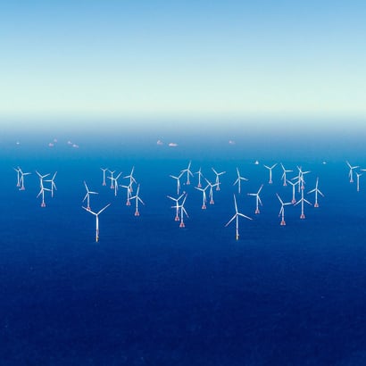 Offshore windfarm on blue seas.