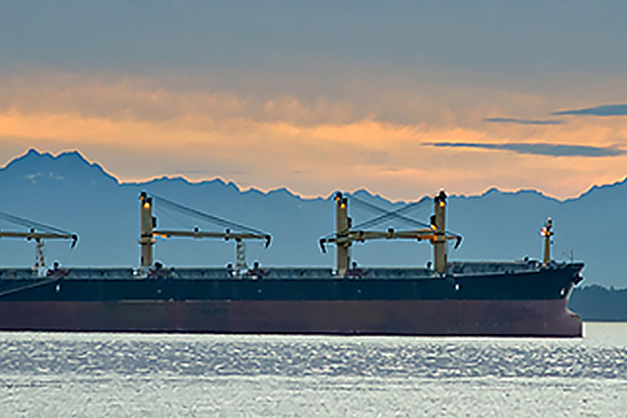 Ship on ocean at sunset.