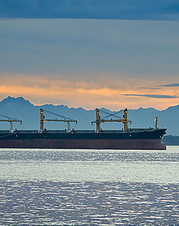 Ship on ocean at sunset.